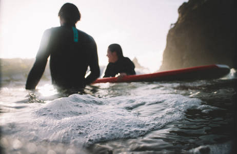 Surfers in het water van Nieuw-Zeeland | Beste reistijd februari | Beste bestemmingen februari | Reiskalender | KILROY